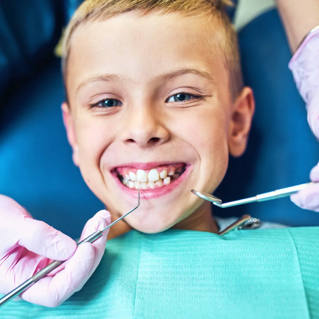 pediatric patient smiling before getting tooth extraction