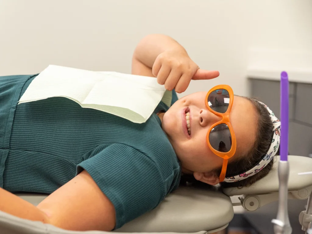 a patient at Tyler Pediatric Dentistry smiling during treatment